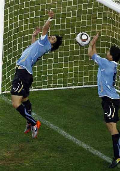 Uruguay's Luis Suarez handles the ball