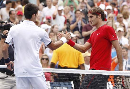 Novak Djokovic of Serbia is congratulated by Roger Federer of Switzerland after Djokovic won their semi-final match at the U.S. Open tennis tournament in New York
(Reuters)
