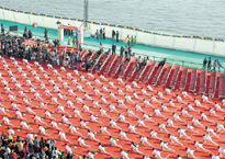 Children perform yoga on riverfront