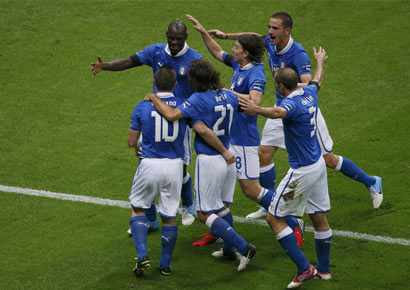 Italy`s Mario Balotelli (L) celebrates with team mates after scoring a goal against Germany during their Euro 2012 semi-final soccer match at the National stadium in Warsaw.