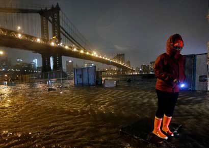 A local resident navigates the flooded streets of the DUMBO neighborhood of Brooklyn, New York A local resident navigates the flooded streets of the DUMBO neighborhood of Brooklyn, New York