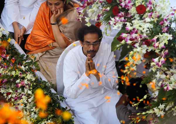 Supporters of the Shiv Sena party throw flowers as Uddhav Thackeray, son of right-wing Hindu nationalist politician Bal Thackeray, who is clasping his hands to thank supporters, during Bal Thackeray's funeral procession in Mumbai.
Thackeray, one of India's most polarising politicians and leader of an influential right-wing Hindu nationalist party that has dominated politics in the country's richest city for two decades, has died aged 86. Thackeray died of cardio-respiratory arrest on Saturday at his home, one of his doctors, Jalil Parker, said. He had been ill for some time and was rumoured to have died earlier this week.
(Reuters)