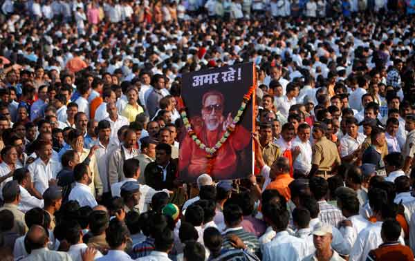Supporters of the Shiv Sena party carry a portrait of right-wing Hindu nationalist politician Bal Thackeray before his funeral procession in Mumbai.
Thackeray, one of India's most polarising politicians and leader of an influential right-wing Hindu nationalist party that has dominated politics in the country's richest city for two decades, has died aged 86. Thackeray died of cardio-respiratory arrest on Saturday at his home, one of his doctors, Jalil Parker, said. He had been ill for some time and was rumoured to have died earlier this week. The poster reads, "Long live".
(Reuters)