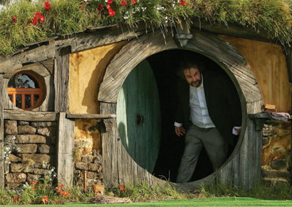 Director Sir Peter Jackson emerges from from a Hobbit house before delivering a speech at the <i>The Hobbit: An Unexpected Journey</i> World Premiere.