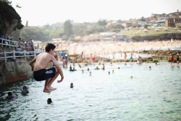 A young boy jumps into the beachside Bronte pool at Bronte beach.
Photo by: Mark Kolbe