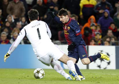Barcelona's Lionel Messi challenges Benfica goalkeeper Artur, just before he was injured, during their Champions League Group G match at the Nou Camp on Wednesday