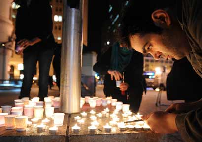 People light candles during a vigil commemorating victims of a Connecticut elementary school shooting in Oakland, California. Twenty six schoolchildren were slaughtered by a heavily armed gunman who opened fire at a suburban elementary school in Connecticut on Friday.