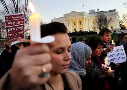 People gather outside the White House to participate in a candle light vigil to remember the victims at the Sandy Hook Elementary School shooting in Newtown, Connecticut.