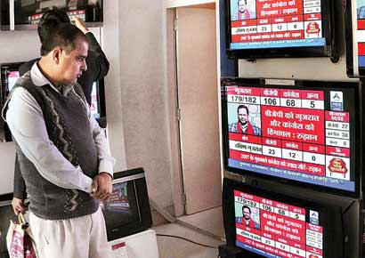 A man watches results of the Assembly elections at a TV showroom in Bikaner. The Congress has been out of power in Gujarat for two decades now.