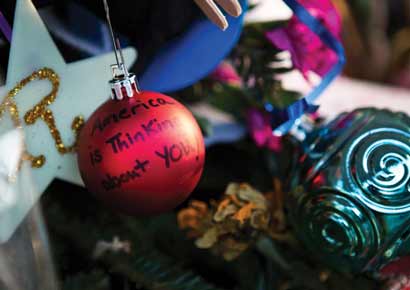 A Christmas tree ornament reads 