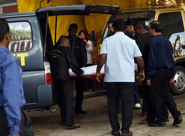 Undertakers remove the body of an Indian rape victim from a van as they prepare to embalm her at a funeral parlour in Singapore.
(Reuters)
