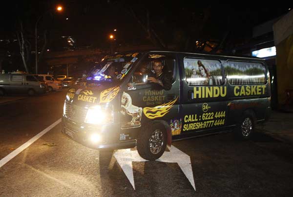 Workers drive a van carrying the coffin of an Indian rape victim as they leave a funeral parlour for the airport in Singapore.
(Reuters)