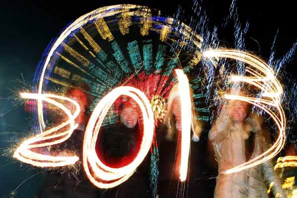 Revellers write the number 2013 with sparklers during the Hogmanay (New Year) street party celebrations in Edinburgh, Scotland
Photo by David Moir