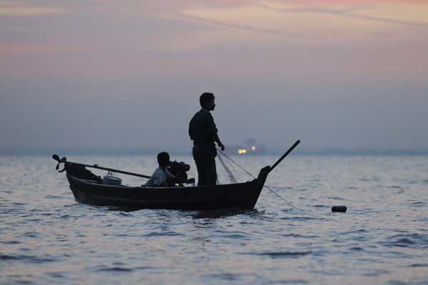 Fisherman fishing along Yangon river as the New Year`s sun rises in Yangon
Photo by Soe Zeya Tun