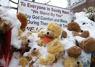 Stuffed bears are seen in the snow as part of a makeshift memorial at Edmond Town Hall in Newtown, approximately three weeks after a gunman shot dead 20 students and six adults at Sandy Hook Elementary, in Newtown, Connecticut on Wednesday. 