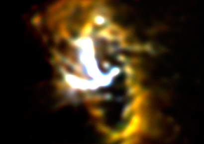 SOFIA/FORCAST mid-infrared image of the Milky Way galaxy's nucleus showing the Circumnuclear Ring (CNR) of gas and dust clouds orbiting a central supermassive black hole. The bright Y-shaped feature is believed to be material falling from the ring toward the black hole that is located where the arms of the 
