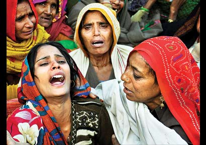 Dharamwati (left), wife of Lance Naik Hemraj Singh who was allegedly killed by Pakistani soldiers on the Line-of-Control in Kashmir, mourns during her husband�s funeral in Mathura district on Wednesday.