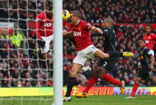 Nemanja Vidic of Manchester United scores the second goal from a deflected Patrice Evra header