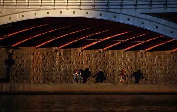 From pedestrians casting shadows as they walk to a woman and her dog looking out of a window. Here are December 16's best pictures.
Pedestrians cast shadows as they walk under a bridge along a footpath on the banks of the Yarra River at sunset in Melbourne.
Photo by David Gray