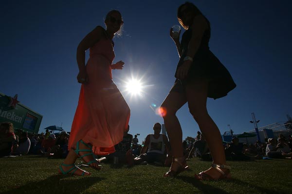 Fans dance at the Heineken Live Stage during day three of the 2013 Australian Open at Melbourne Park.
Photo by Marianna Massey