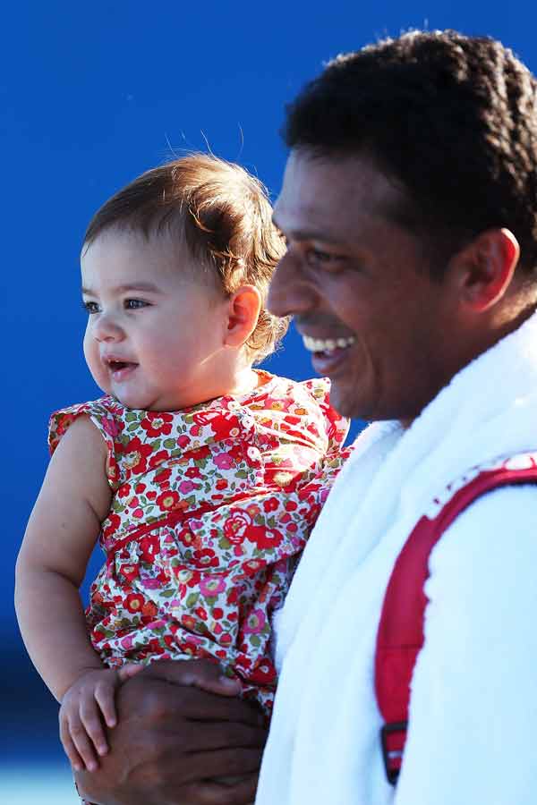 Mahesh Bhupathi of India smiles with his baby Saira, following victory in his first round doubles match with Daniel Nestor of Canada against Pablo Andujar of Spain and Guillermo Garcia-Lopez of Spain during day three of the 2013 Australian Open at Melbourne Park on January 16, 2013 in Melbourne, Australia.
Photo by: Graham Denholm
(Reuters)