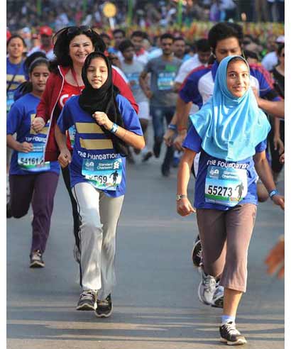 Two school girls pick up pace in the Mumbai Marathon 2013 on Sunday.