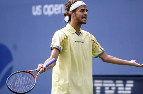 What's wrong Kuerten?
It was meant to be just a formality for second-seed Gustavo Kuerten in the first round of 2000 US Open. But qualifier Wayne Arthurs ensured it would be his last in the tournament. The Aussie, ranked 102, beat Guga 4-6, 6-3, 7-6, 7-6.
(Getty Images) Gustavo Kuerten of Brazil reacts during his match at the 2000 US Open.