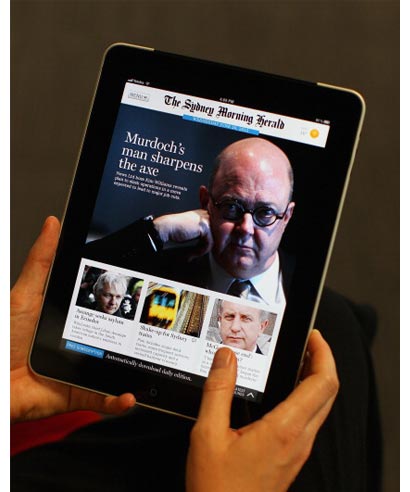 A woman uses an app to read the Sydney Morning Herald on an iPad in Sydney on June 20, 2012.