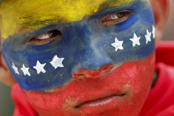 A Venezuelan soldier, with his face painted with colours of the national flag, attends a military parade to commemorate the 21st anniversary of Venezuelan President Hugo Chavez`s attempted coup d`etat in Caracas.
Photo by: Jorge Silva
(Reuters)