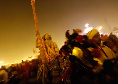 A sadhu rides a horse before he takes a dip during the second 
