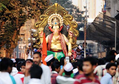 Devotees carrying the Charkopcha Raja from the sculptor's workshop to the mandal on Sunday.