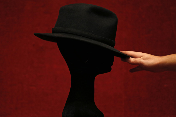 An assistant displays a black Fedora hat owned by late singer Michael Jackson at Drouot auction house in Paris on Monday. The hat, made 1984 by Maddest Hatter in Los Angeles, estimated for between 4-5,000 euros, was worn by singer Jackson during the last 'Victory Tour' concert in New York, August 25, 1984.
Photo by: Christian Hartmann (Reuters)
(Reuters)