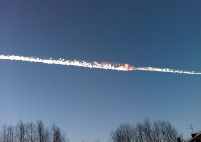 The trail of a falling object is seen above the Urals city of Chelyabinsk in Russia on February 15 in this picture provided by <i>www.chelyabinsk.ru</i>. The trail of a falling object is seen above the Urals city of Chelyabinsk in Russia on February 15 in this picture provided by <i>www.chelyabinsk.ru</i>.