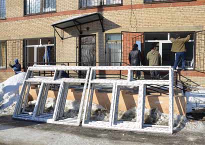 Employees try to fix windows of a maternity ward at hospital number 9, which was damaged by a shockwave from a meteorite, in the Urals city of Chelyabinsk, Russia.