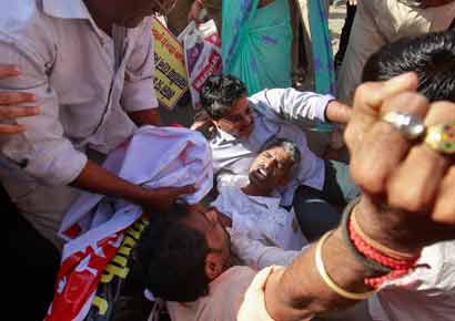 Workers from various trade unions shout slogans as they try to block a road during a strike in Mumbai on Wednesday.