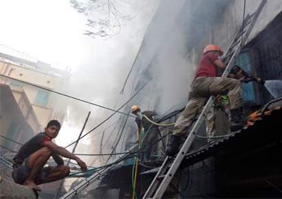 Fire fighters try to extinguish a fire at a multi-storey market complex in Kolkata