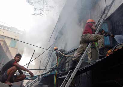 Fire fighters try to extinguish a fire at a multi-storey market complex in Kolkata on Wednesday. 