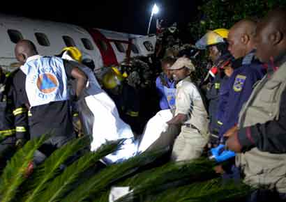 United Nations (UN) rescuers remove bodies amidst the wreckage where a twin-propeller plane crashed at Goma airport in eastern Congo in this handout photo released by MONUSCO on March 4.