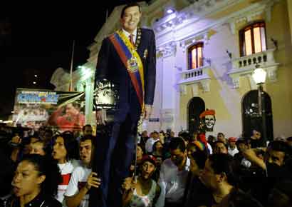 Supporters of Venezuela's President Hugo Chavez react to the announcement of his death outside Miraflores Palace in Caracas.