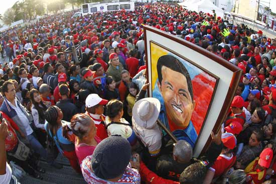 Supporters of Venezuela's late President Hugo Chavez wait for a chance to view his body at the military academy in Caracas March 8, 2013. Chavez will be embalmed and put on display 