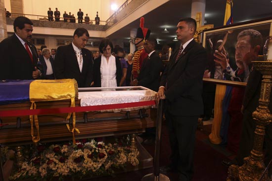 Ecuador's President Rafael Correa (2nd L) views the body of late Venezuelan President Hugo Chavez as he visits the wake with his wife Ann Malherbe (R) and Venezuela's acting President Nicolas Maduro (L) at the military academy in Caracas March 7, 2013, in this picture provided by the Miraflores Palace. Chavez will be embalmed and put on display 