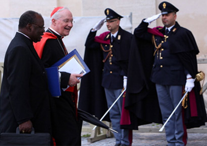 Canadian cardinal Marc Ouellet (R) and Archbishop of Kinshasa Laurent Monsengwo Pasinya (L) leave the Paul VI Hall at the end of a session of cardinals general congregations on March 7, 2013 in Vatican City, Vatican. 