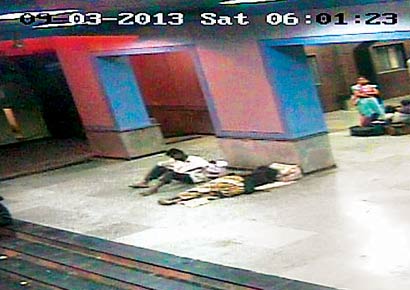 CCTV camera footage shows an unidentified man lifting the baby away from his mother's side