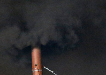 Black smoke rises from the chimney on the roof of the Sistine Chapel in the Vatican City indicating that no decision has been made after the first day of voting for the election of a new pope, March 12, 2013.