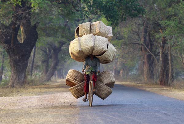 A woman cycles as she carries baskets to sell in a market near Lapdaung mountain in Sarlingyi township.
Photo by Soe Zeya Tun
(Reuters)