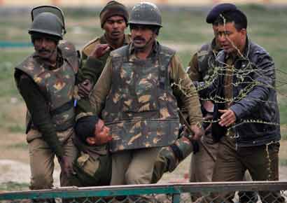 CRPF jawans carry their injured colleague to a hospital after their camp was attacked by two suicide bombers. 