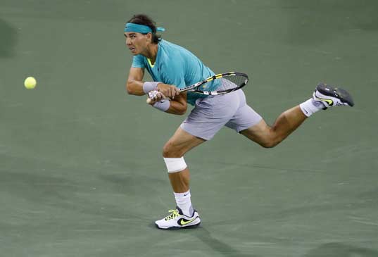 Rafael Nadal of Spain returns a shot against Roger Federer of Switzerland during their men's singles quarterfinal match at the BNP Paribas Open ATP tennis tournament in Indian Wells, California, March 14, 2013. 