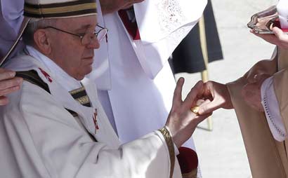 The Fisherman's Ring is placed on the finger of Pope Francis by Cardinal Angelo Sodano, Dean of the College of Cardinals during his inaugural mass at the Vatican