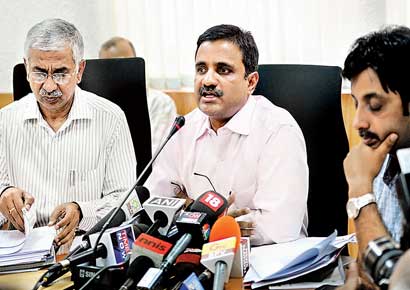 Karnataka chief electoral officer Anil Kumar Jha (centre) briefs the media in Bangalore.