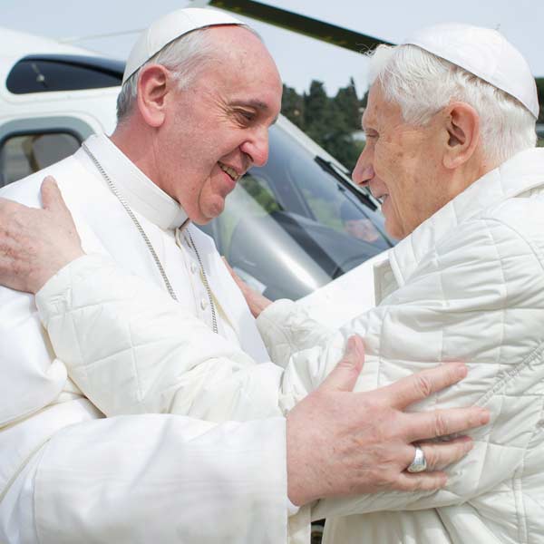 Pope Francis (L) embraces Pope Emeritus Benedict XVI as he arrives at the Castel Gandolfo summer residence on March 23, 2013. Pope Francis travelled by helicopter from the Vatican to Castel Gandolfo for a private meeting with former Pope Benedict XVI. 